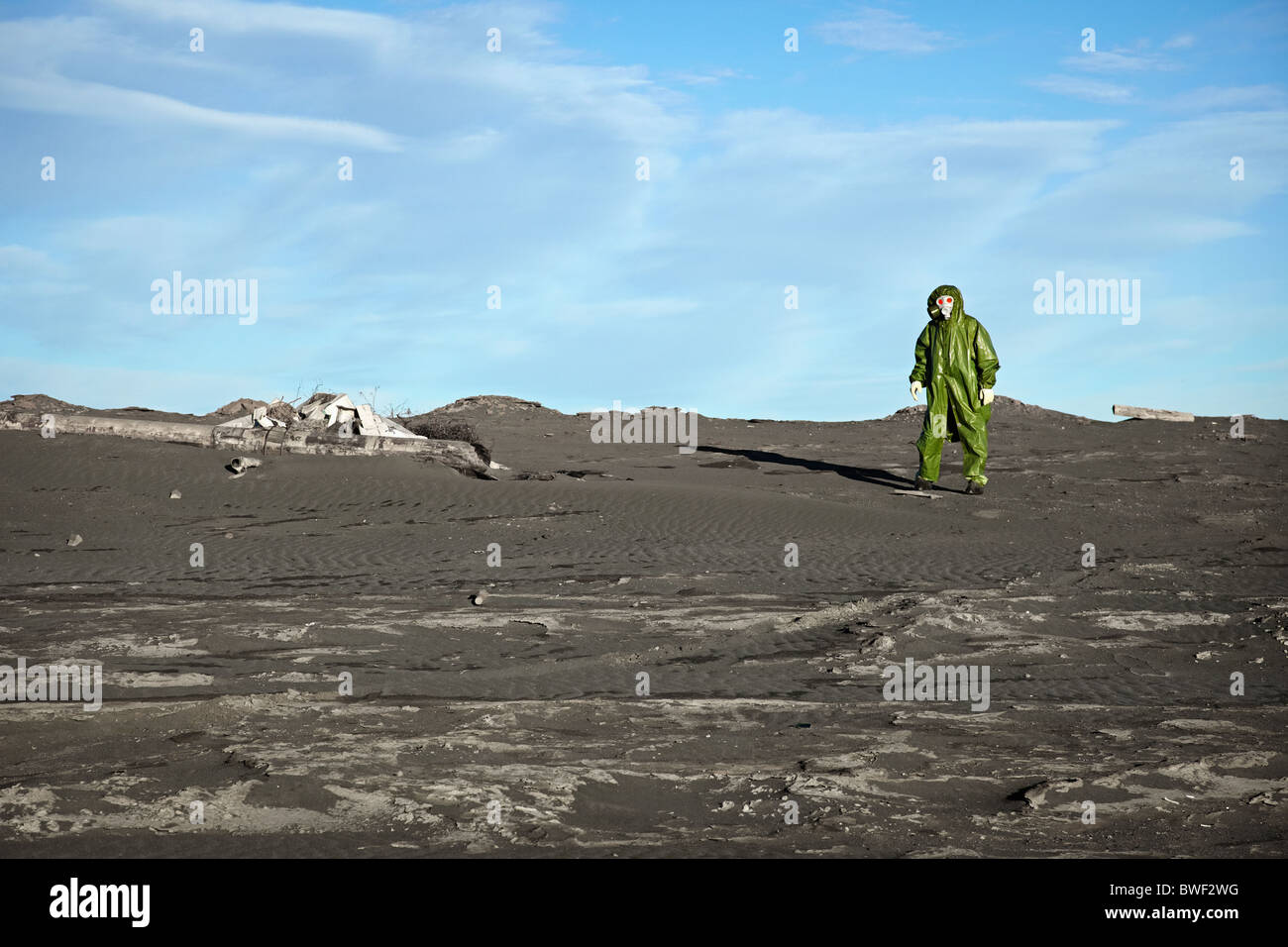 A man in overalls like an alien in the desert Stock Photo