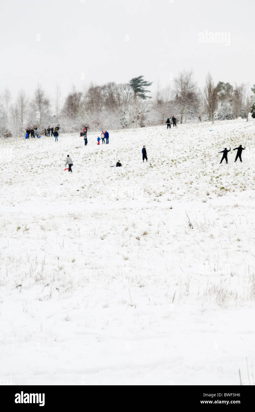 snow scene with people enjoying and playing in the snow on hill in Bristol, uk Stock Photo