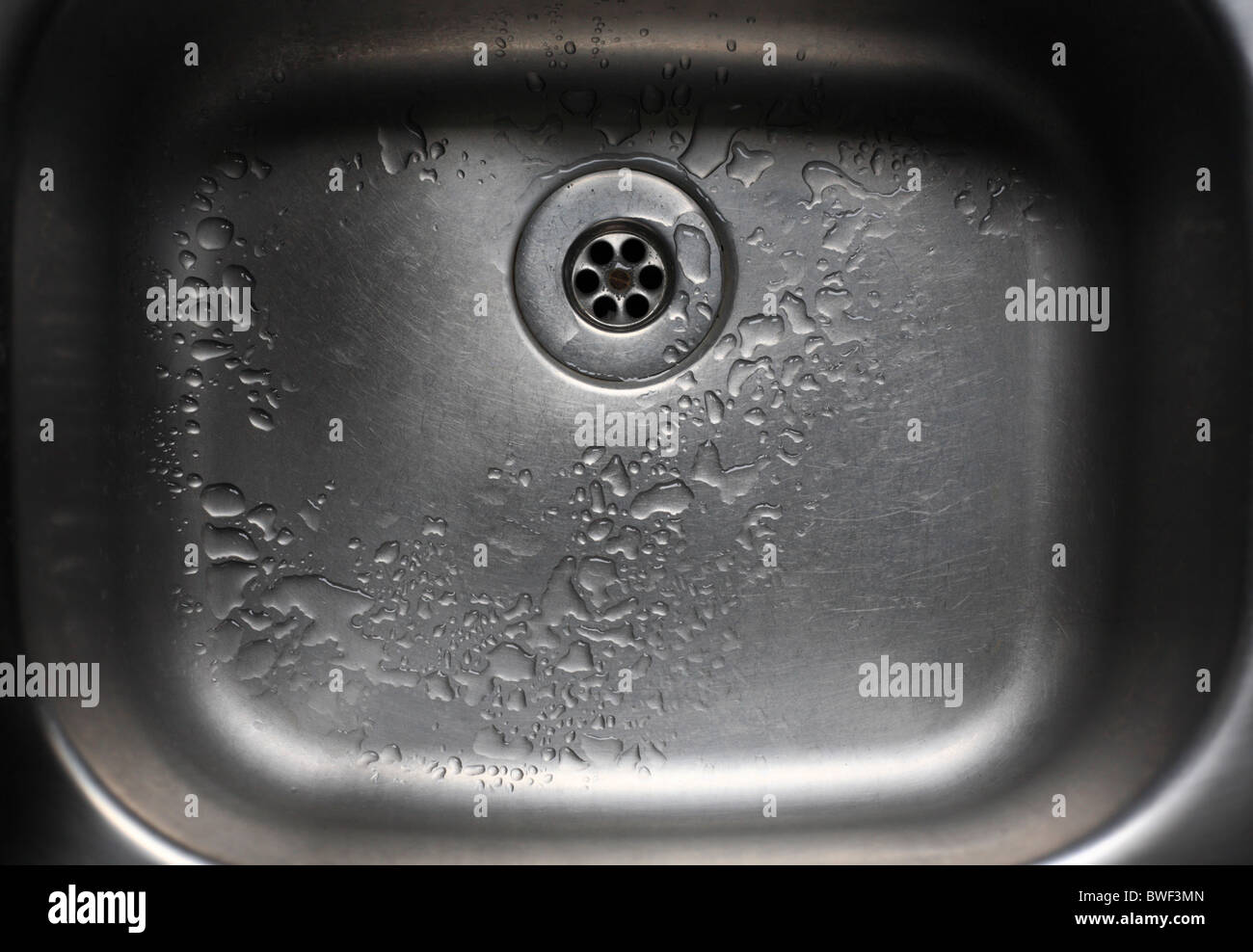 A stainless steel kitchen sink. Stock Photo