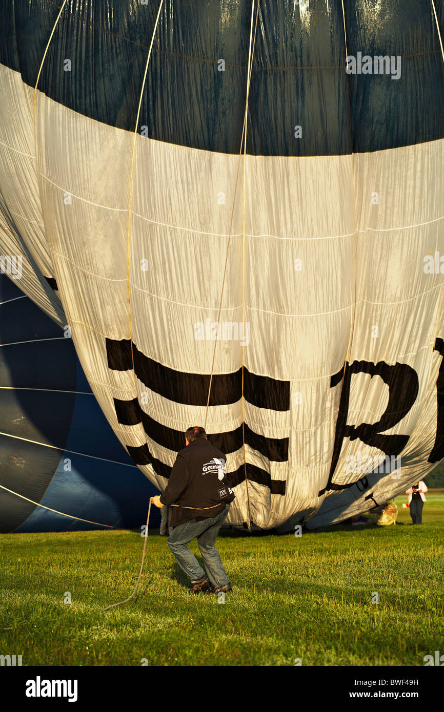 Man holding a hot air balloon as its being inflated Stock Photo