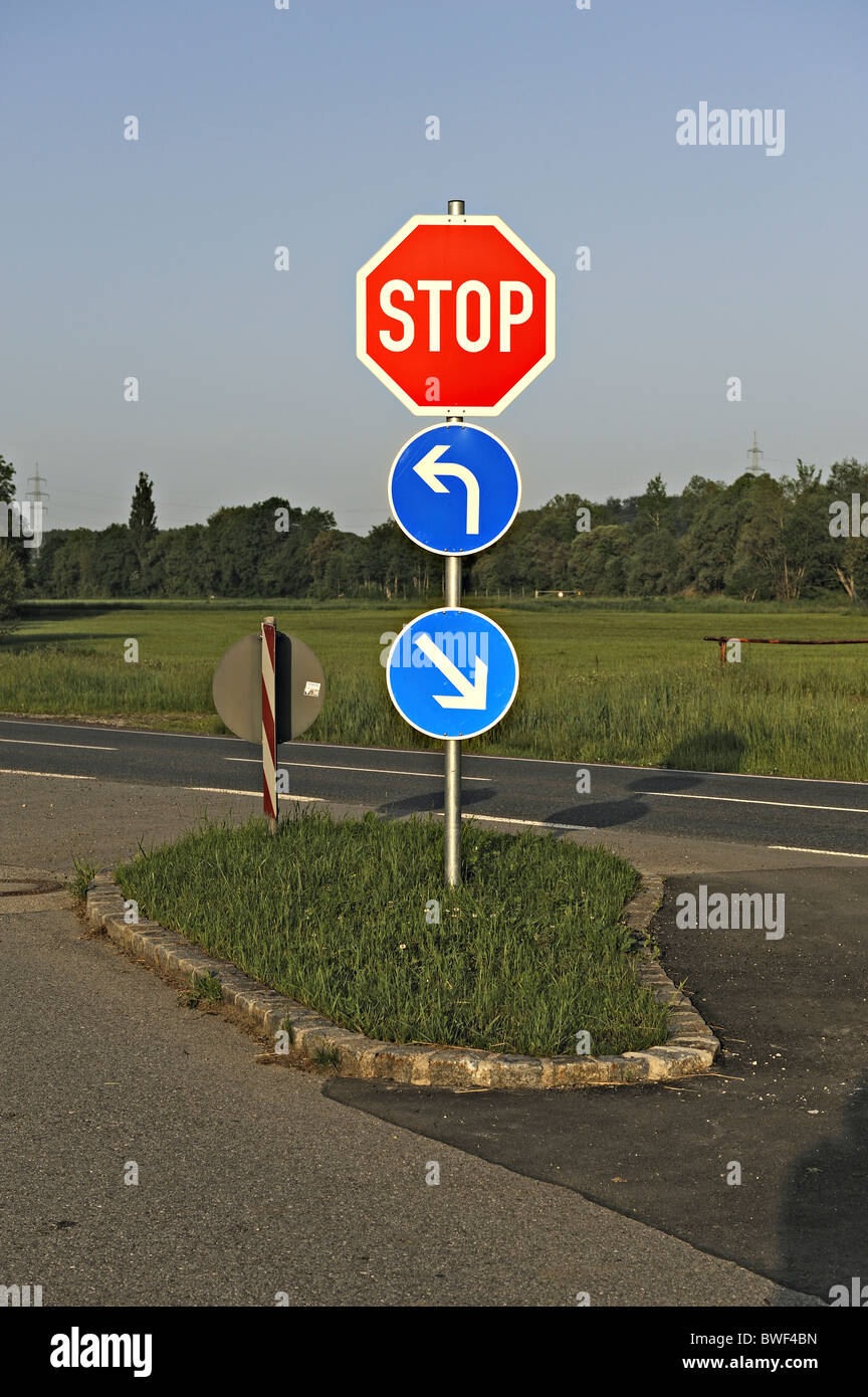 Road sign stop turn right left Stock Photo