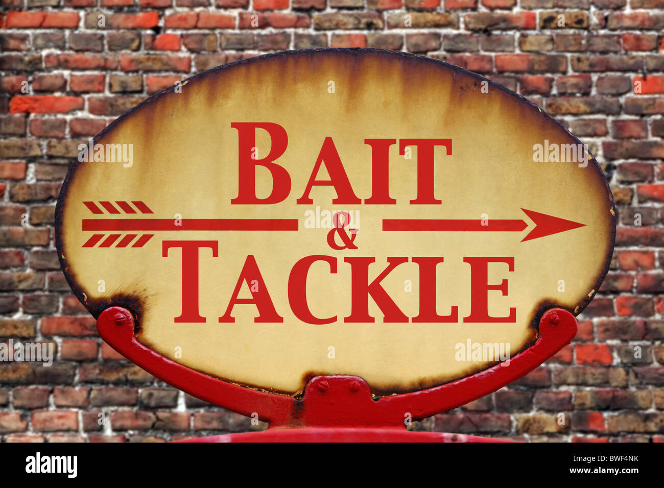 A rusty old retro arrow sign with the text Bait and Tackle Stock Photo