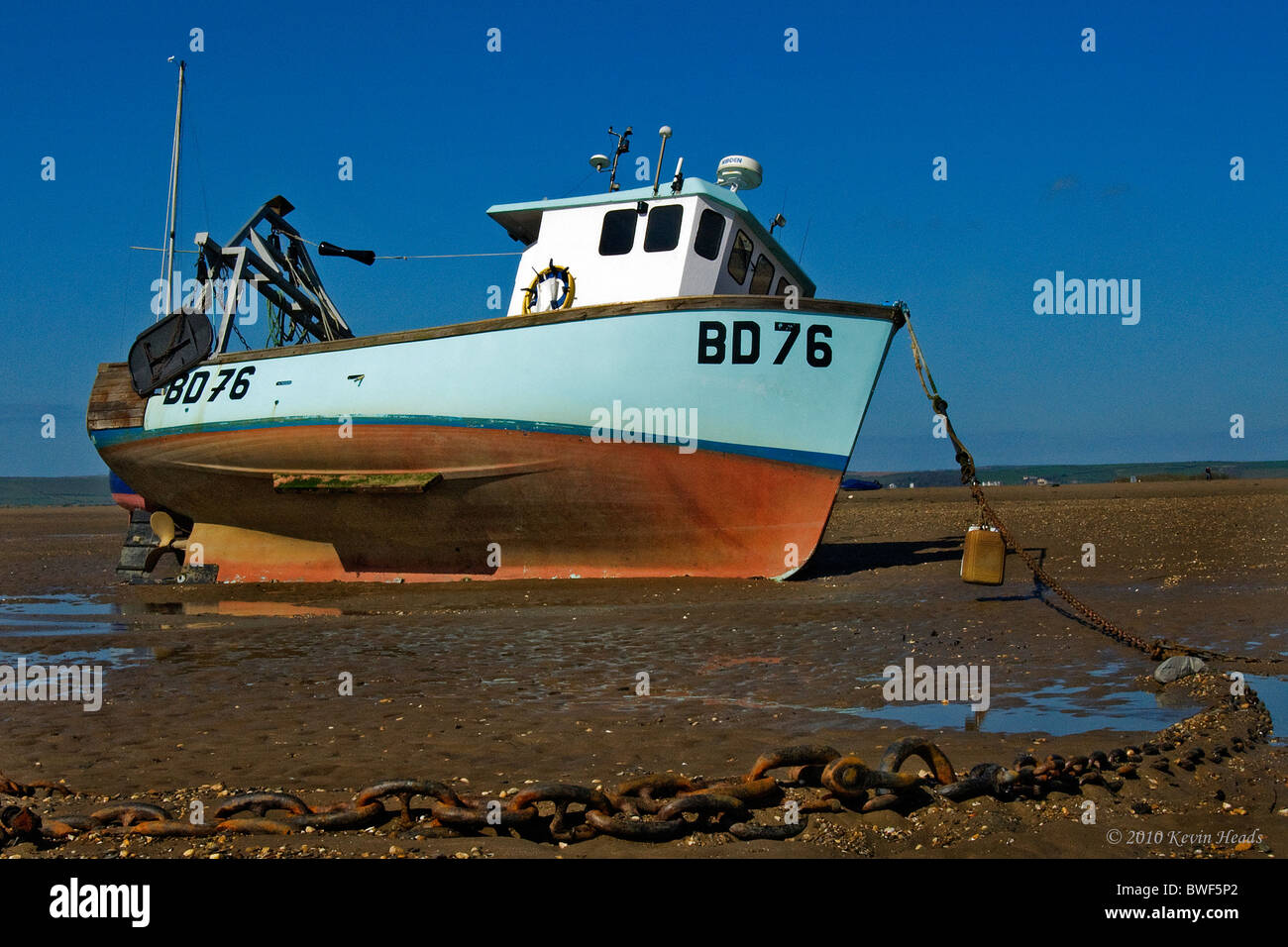 Fishing Boat Beached At Low Tide Stock Photos & Fishing Boat Beached At