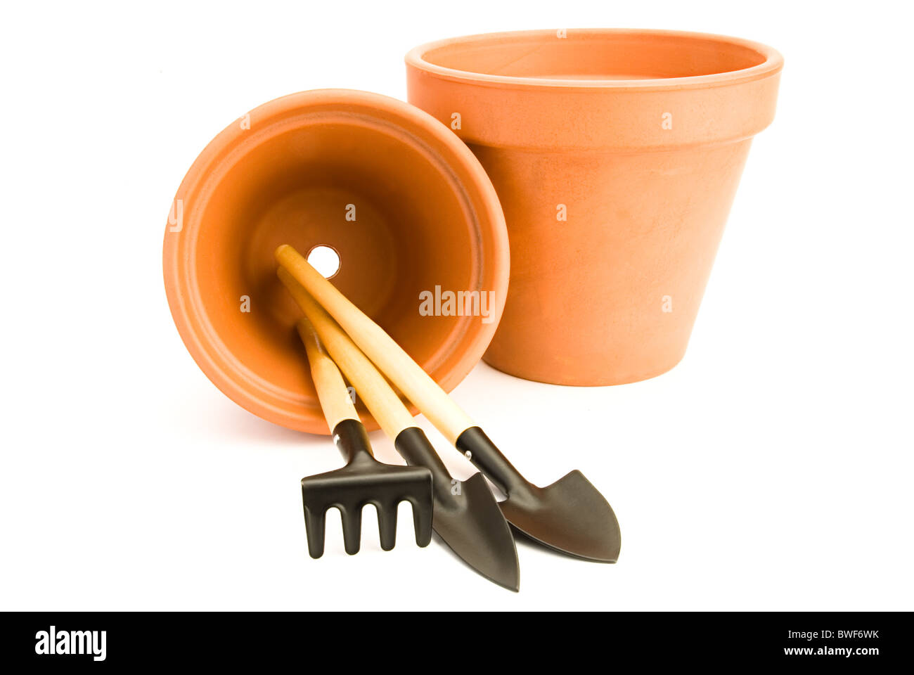terracotta flower pots and gardening tools Stock Photo