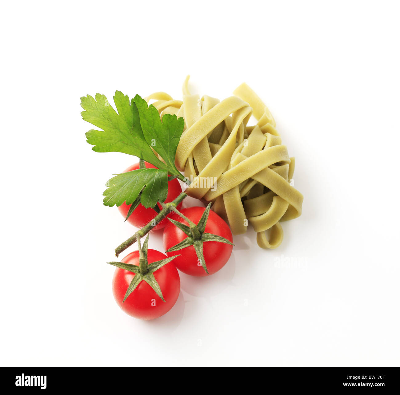 Green ribbon pasta and fresh tomatoes Stock Photo