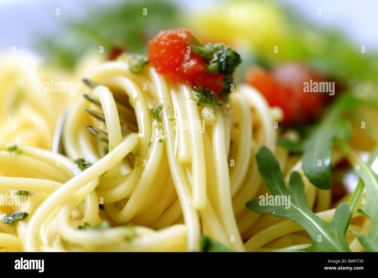 Macro shot of spaghetti twirled around a fork Stock Photo