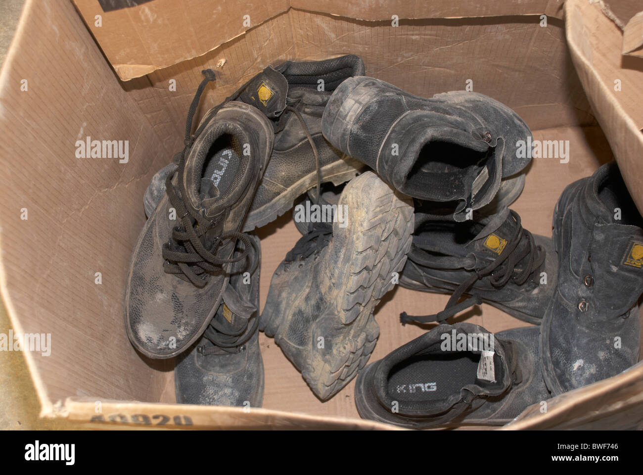 dirty steel toe capped boots in a box at construction training school Stock Photo