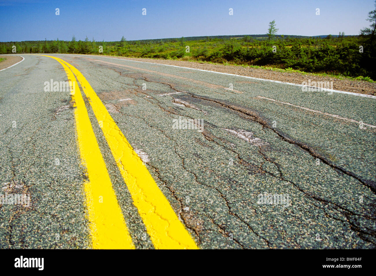 Empty paved road with yellow double line Stock Photo