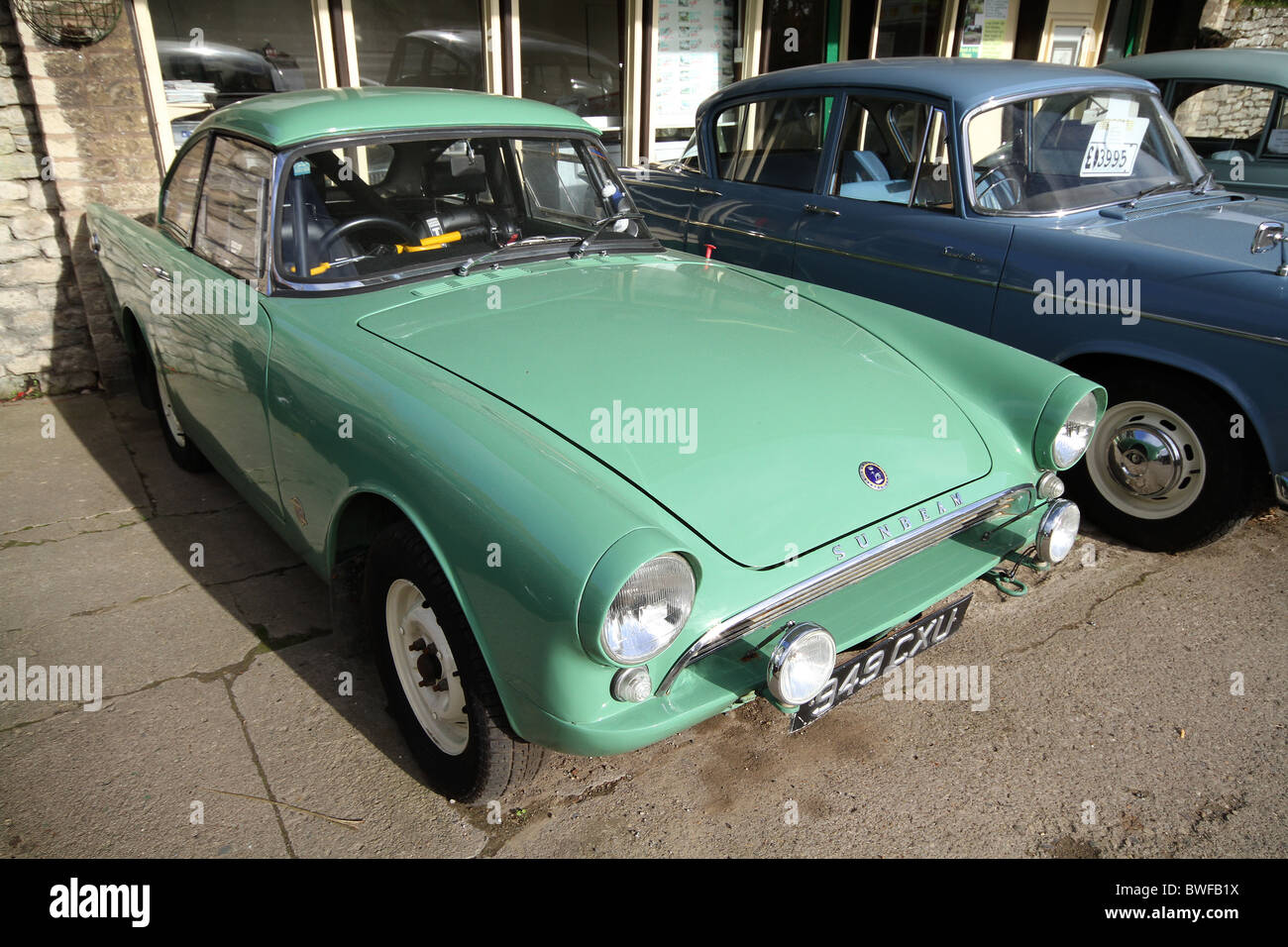 Sunbeam Alpine old sports car used for racing then offered for sale in garage. Stock Photo