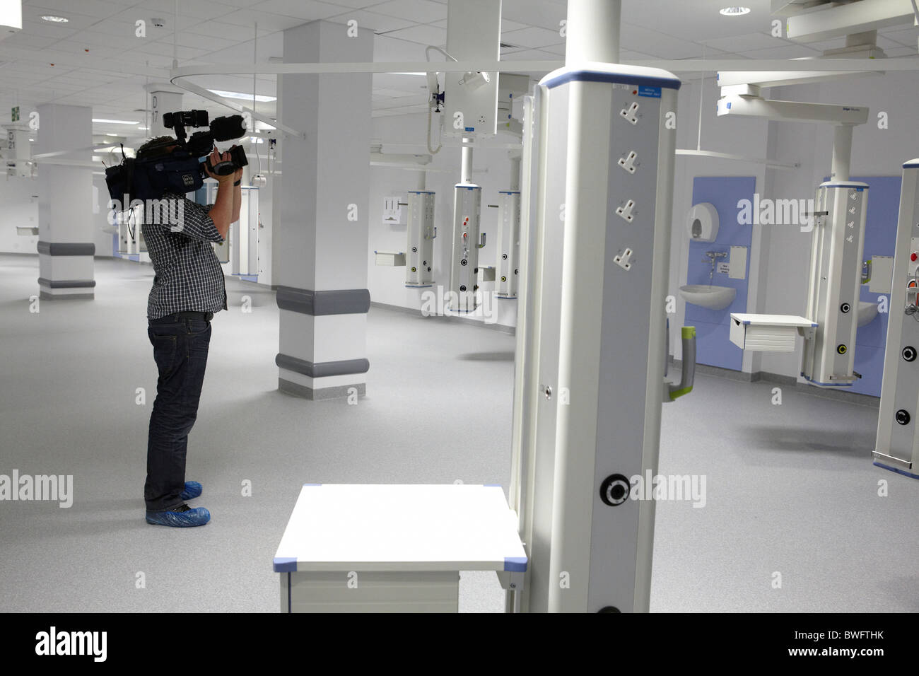 A television cameraman films inside the new QE hospital in Birmingham. Stock Photo