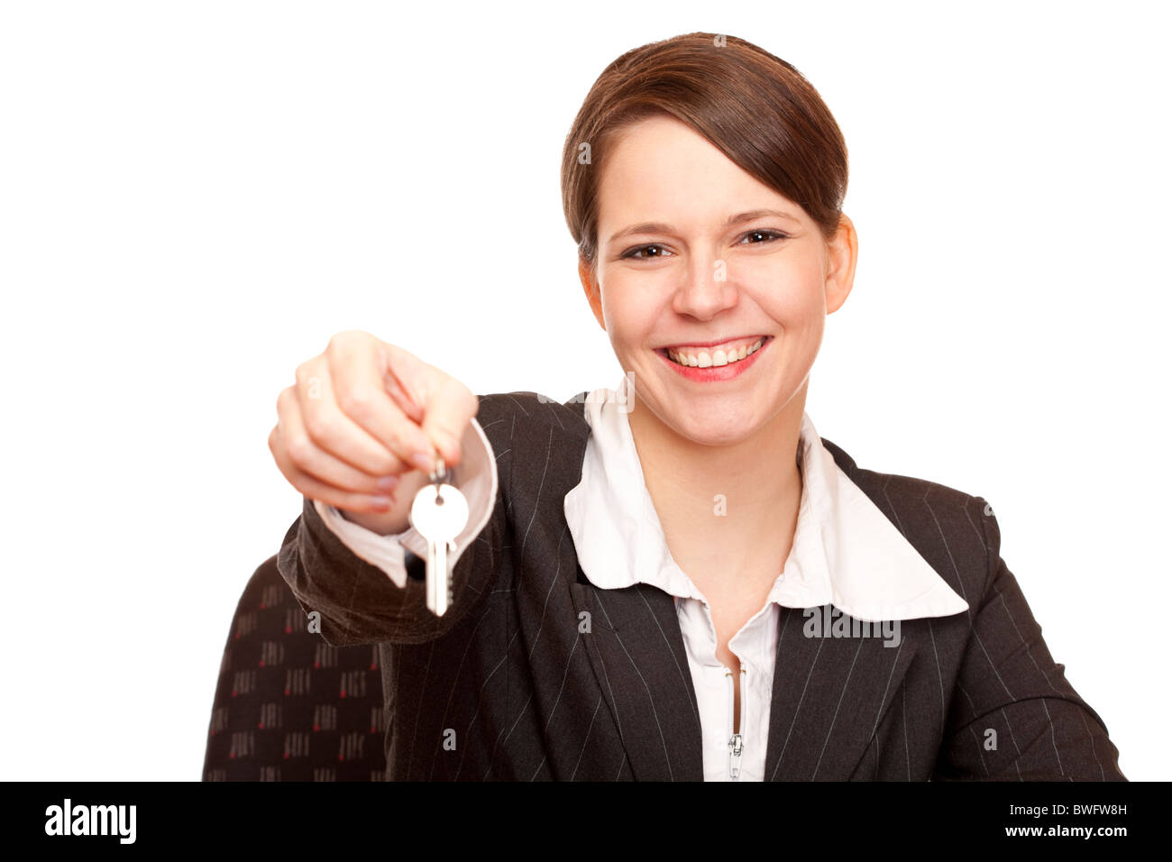 Smiling woman gives over house key. Isolated on white background Stock Photo