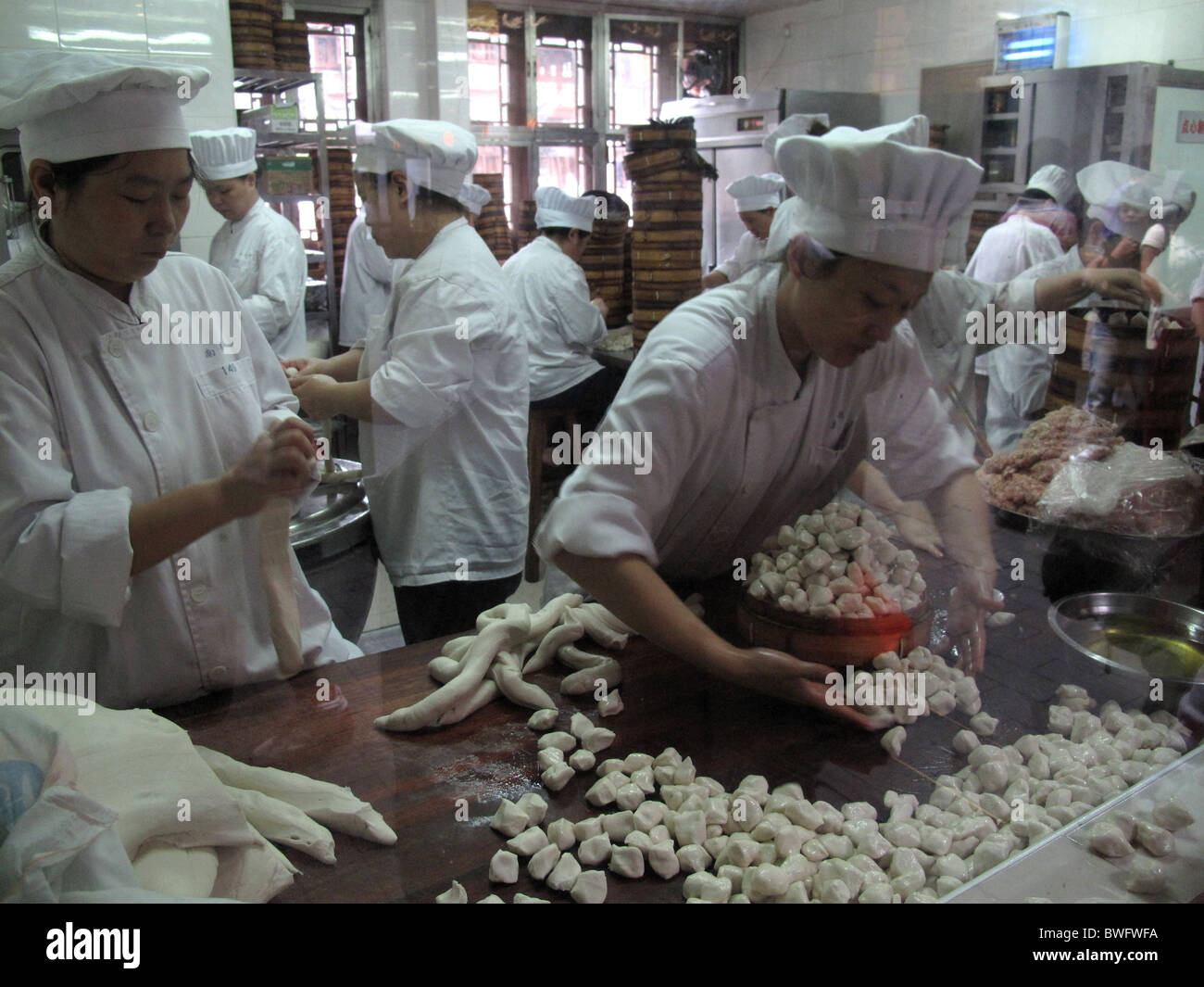 Dumplings restaurant in Shanghai, CHINA. dumpling cook cooking chinese kitchen food women woman work working worker Stock Photo