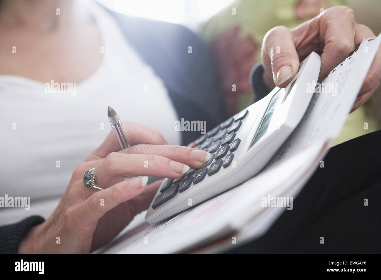 Close-up of woman's hands on calculator Stock Photo