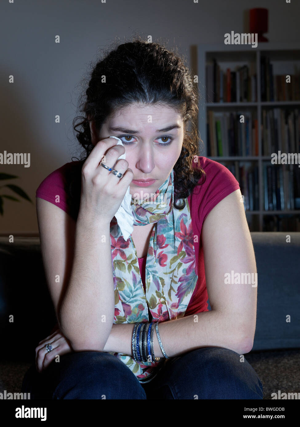 Young woman weeping watching television Stock Photo