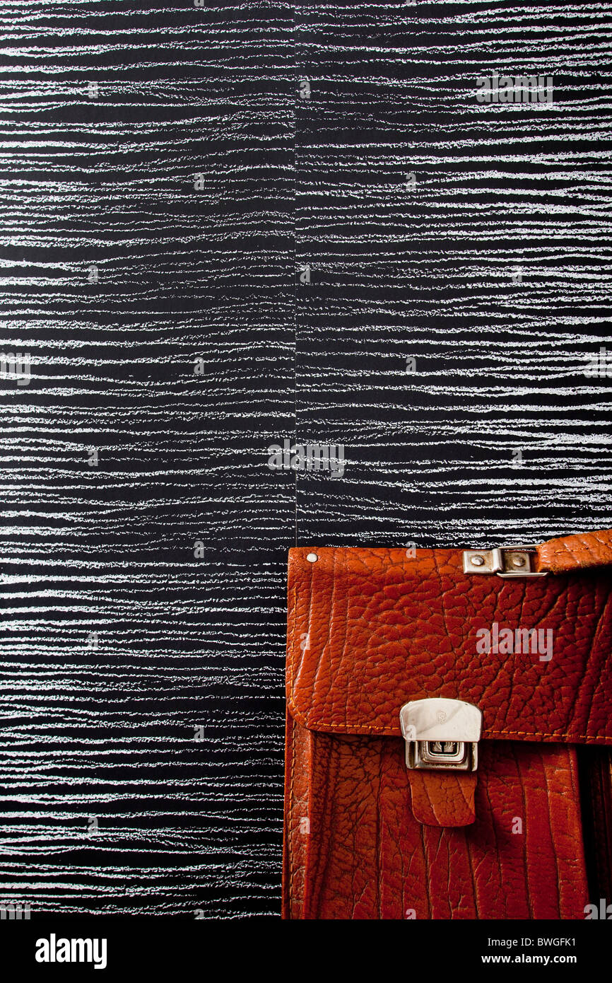 Part of a brown briefcase on streaky wallpaper.Sweden Stock Photo - Alamy