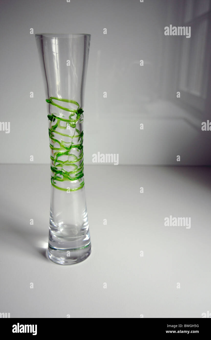 An Empty Thin Glass Vase With Green Pattern On White Background