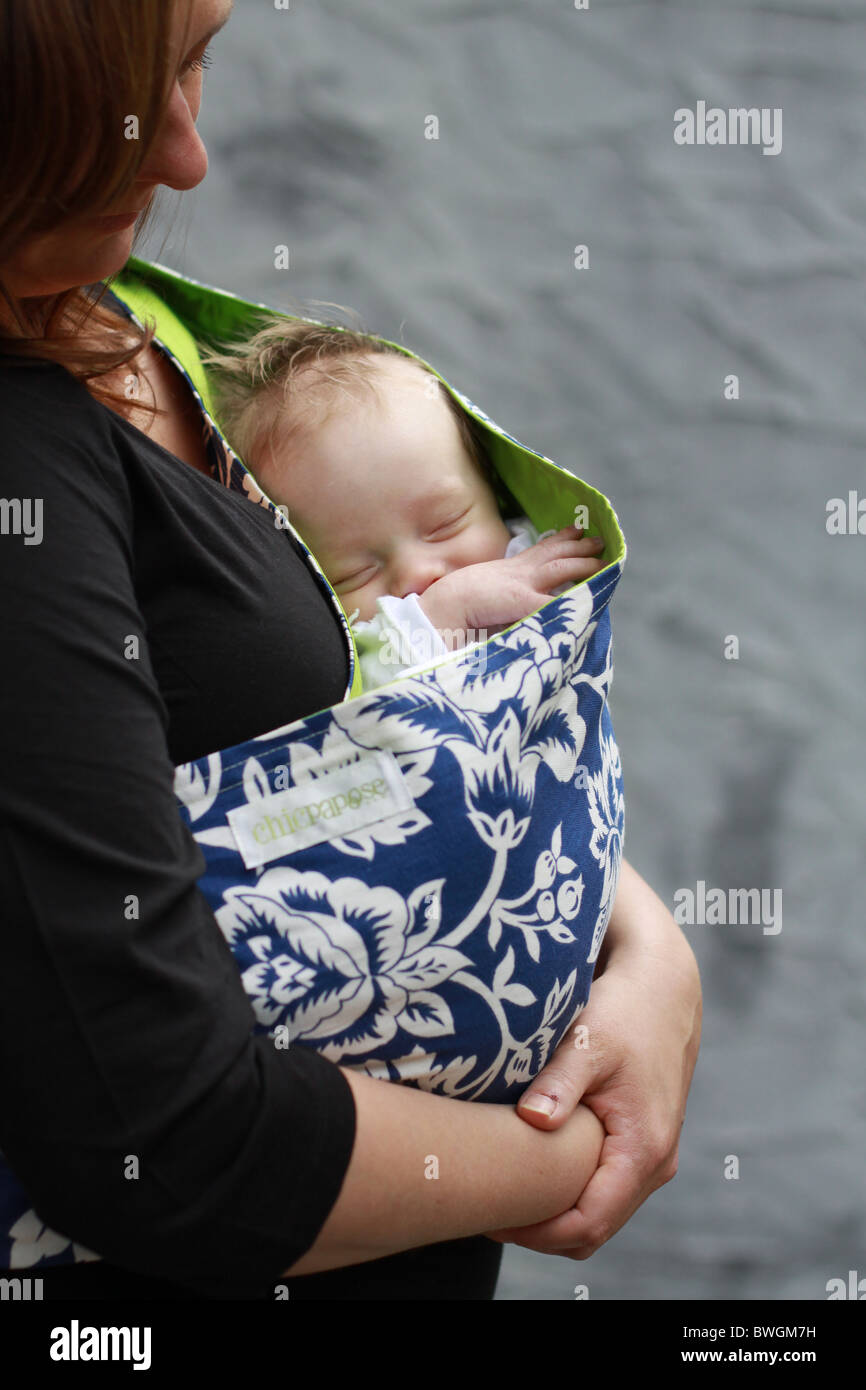 Qoman holding newborn baby in sling Stock Photo Alamy