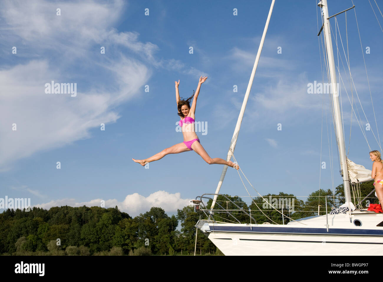 Girl jumping from boat into water Stock Photo Alamy