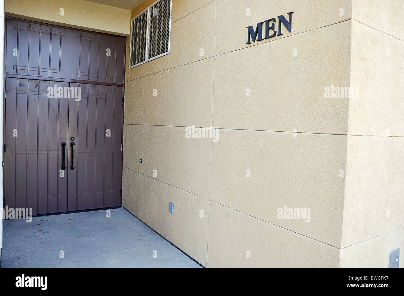 Entrance to men's restroom showing sign and doors. Stock Photo