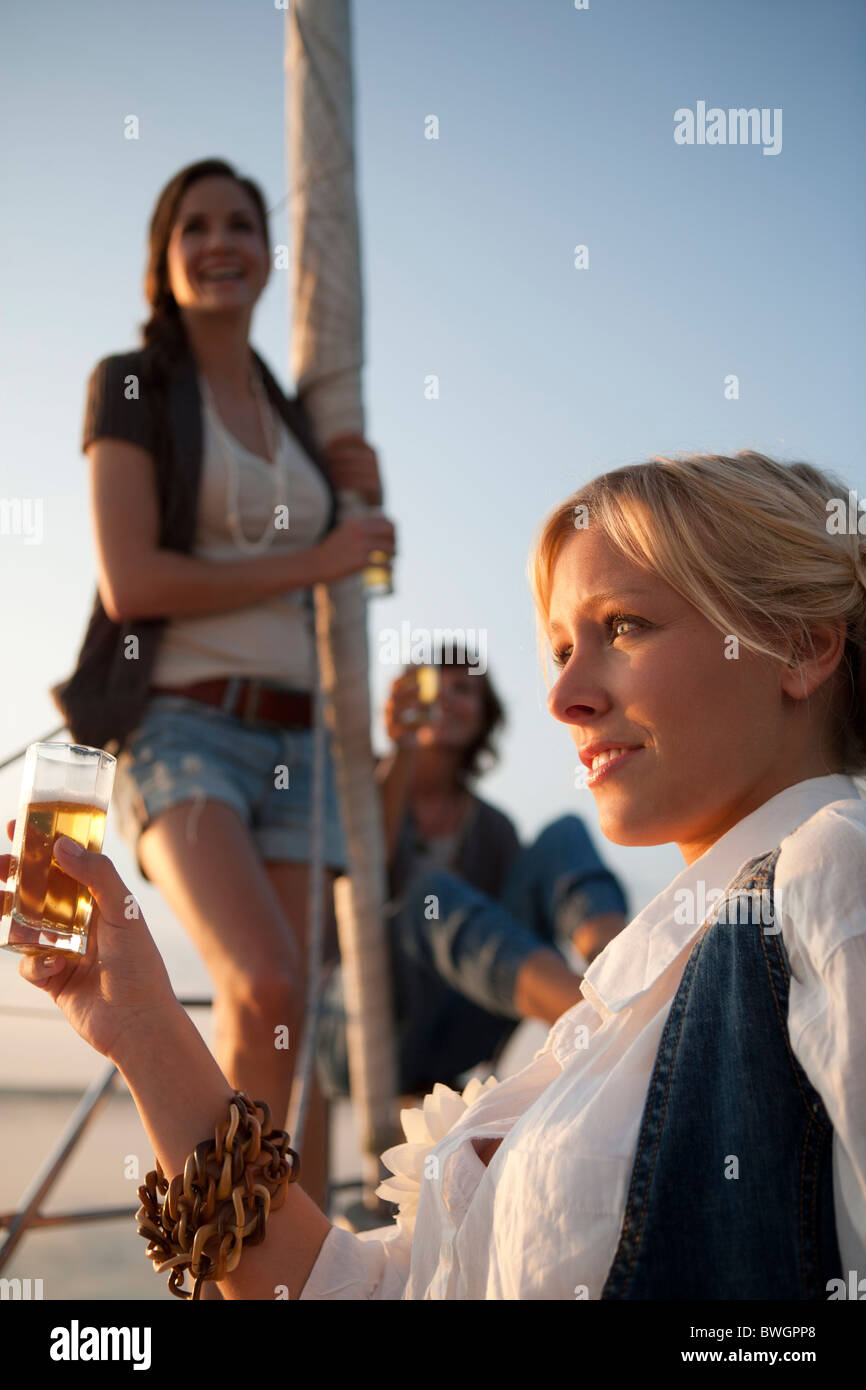 Girls drinking beer on boat Stock Photo Alamy