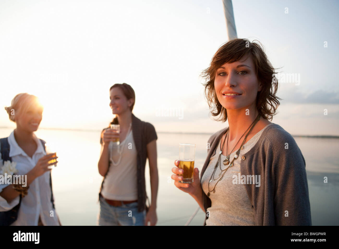 Girls drinking beer on boat Stock Photo Alamy