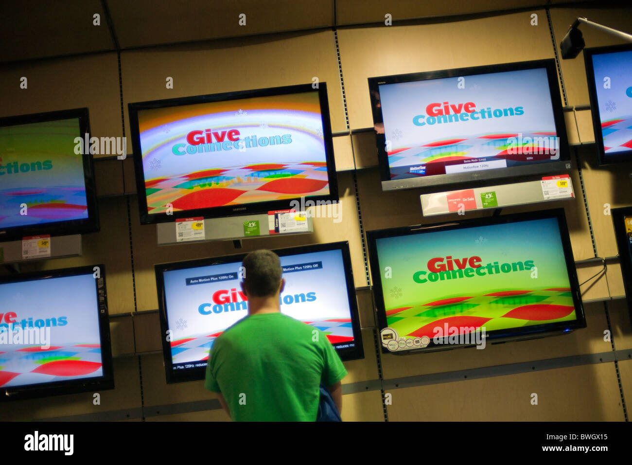 A shopper browses the flat screen television display at a Best Buy