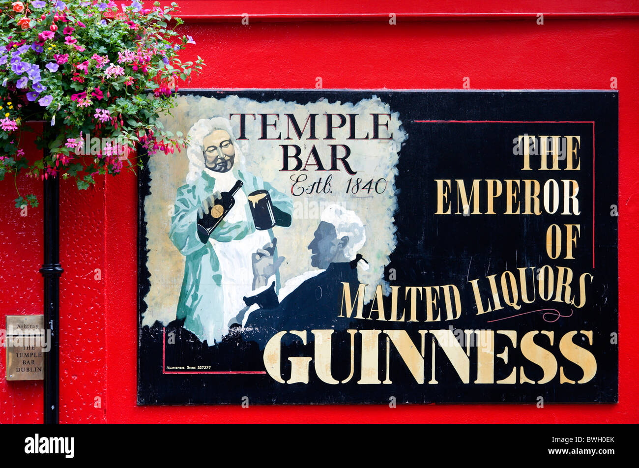 Ireland, County Dublin, Dublin City, Temple Bar pub sign on red wall promoting Guinness. Stock Photo