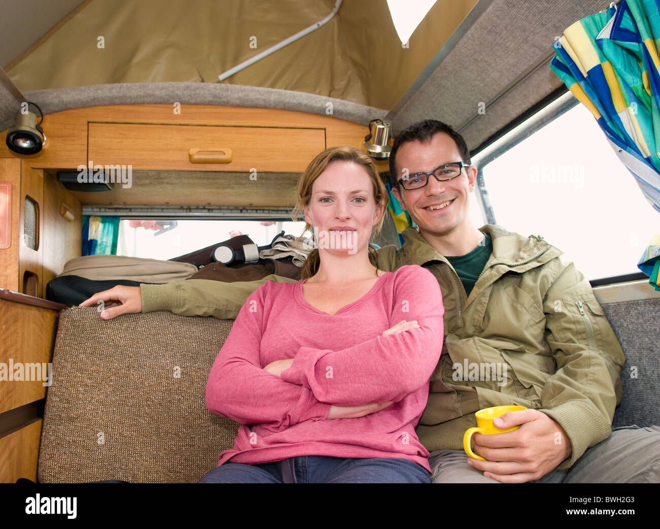 Happy couple sit in camper van Stock Photo Alamy