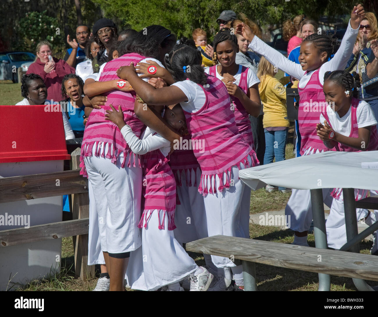 African American girls dancing troupe celebrates with their teacher at pro life rally Fort White Florida Stock Photo