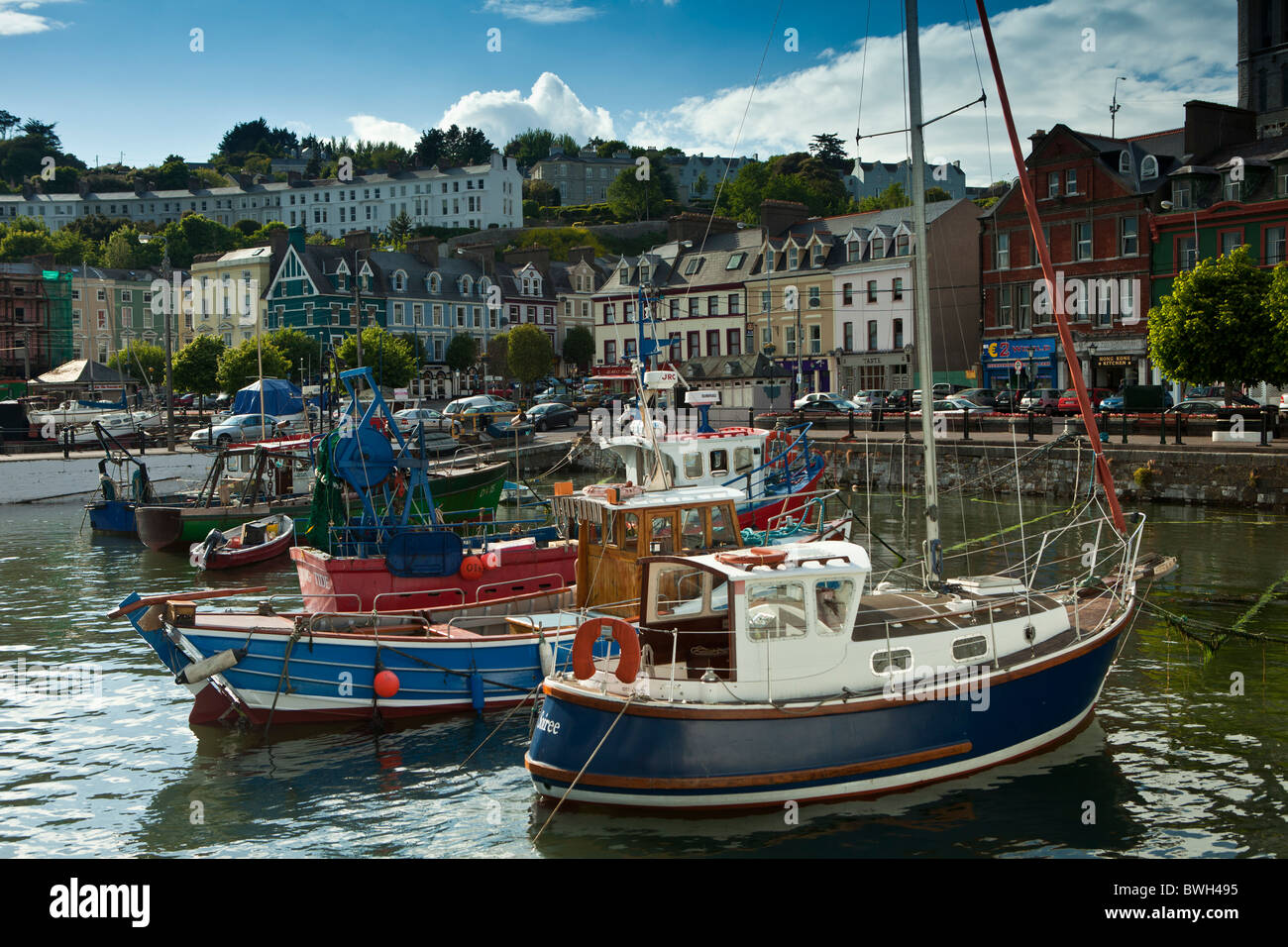 Popular as a tourist destination Cobh harbour with brightly coloured fishing boats in County Cork, Ireland Stock Photo