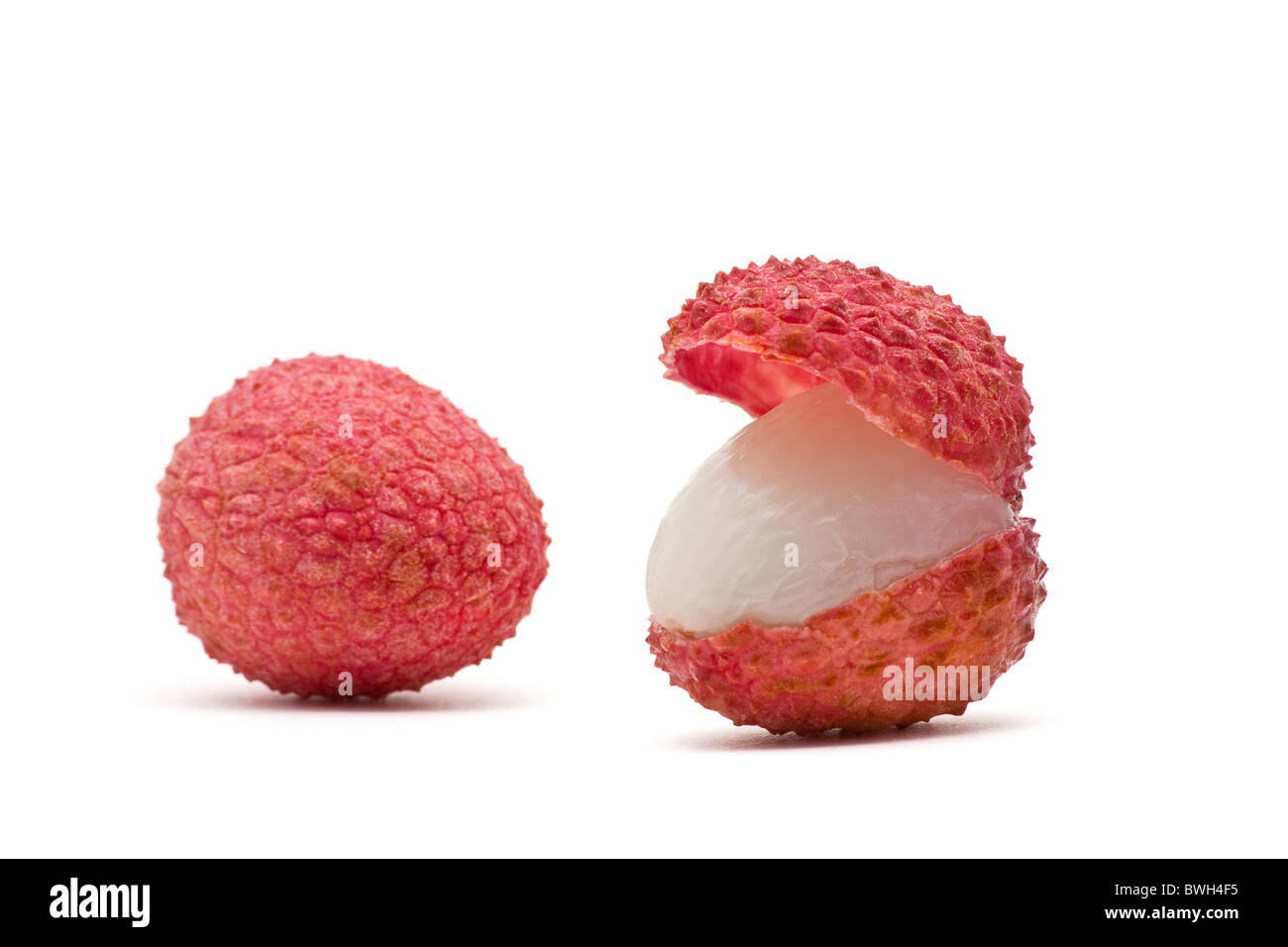 Delicious juicy red lychees over white background Stock Photo