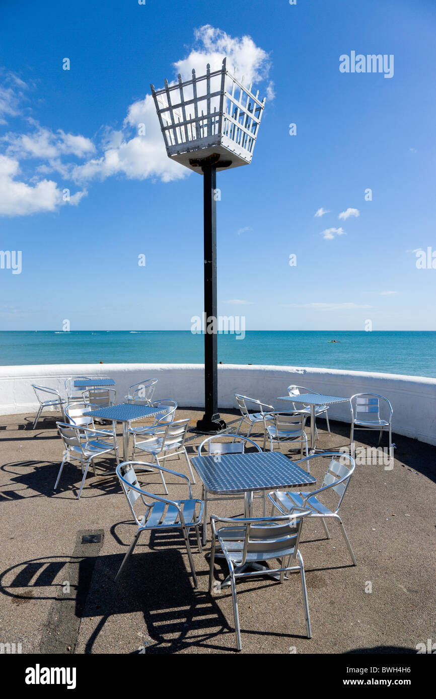 England West Sussex Bognor Regis Millennium Beacon on the seafront beside the beach with empty metal tables and chairs below Stock Photo
