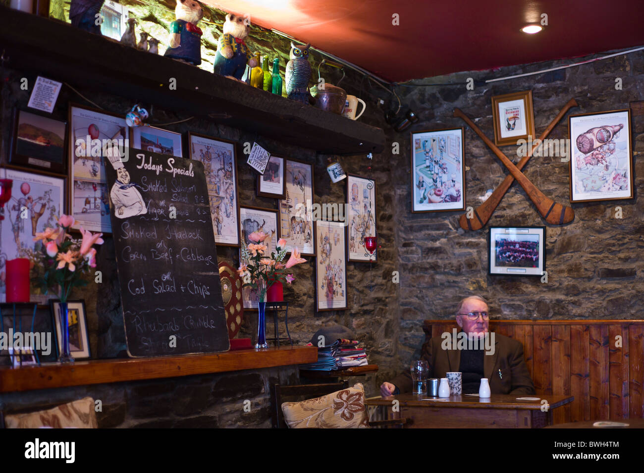 Irish man relaxes in traditional bar in Timoleague, County Cork, Ireland Stock Photo
