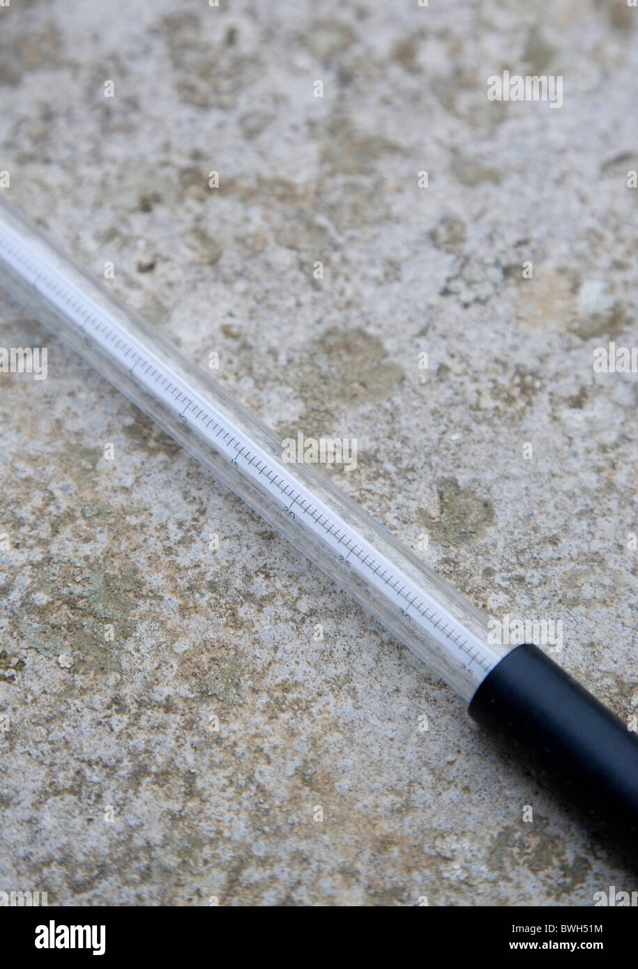 Climate Weather Station Measurement Thermometer laid on concrete to measure the minimum overnight concrete temperature Stock Photo