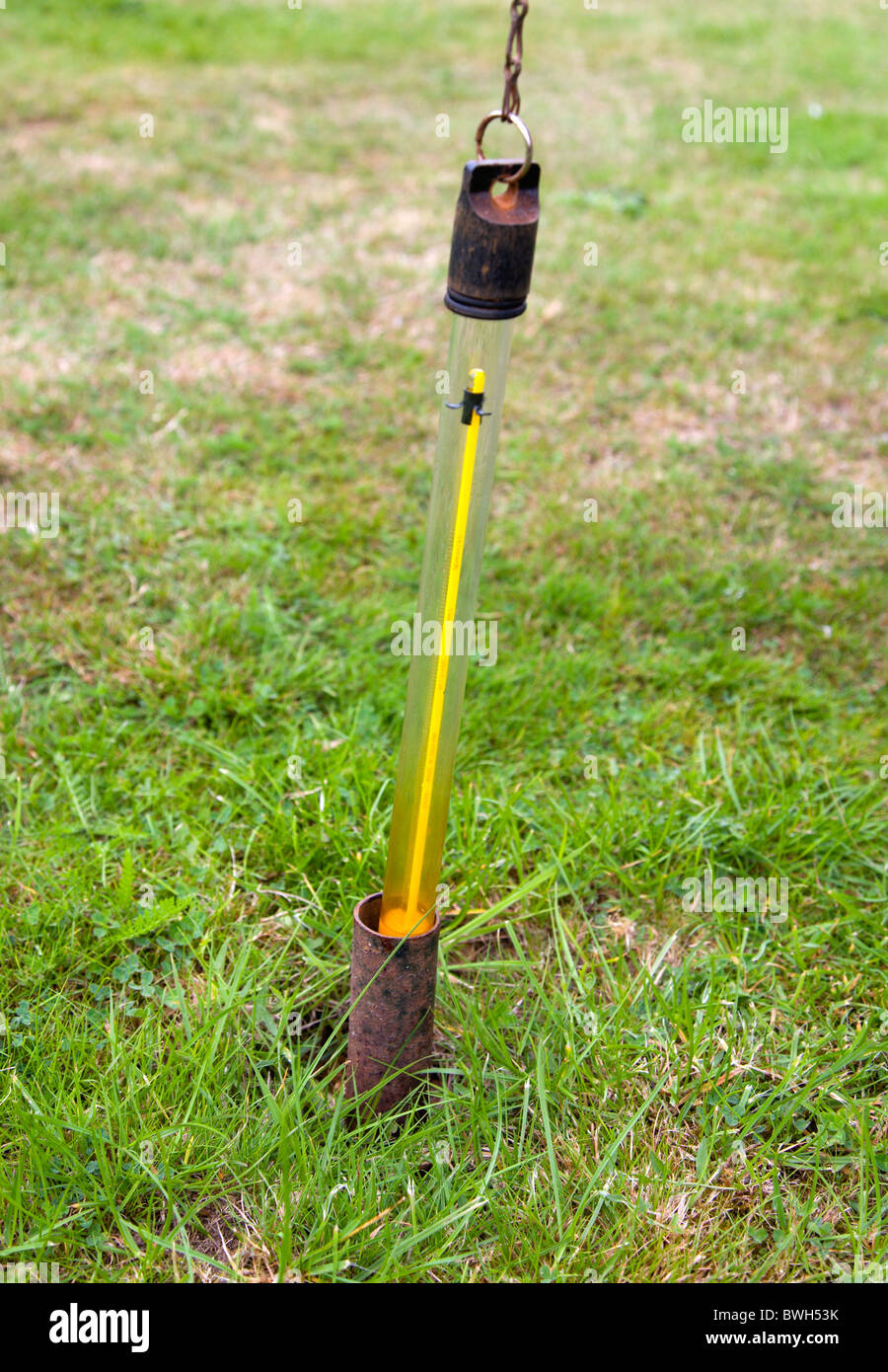 Climate Weather Measurements Thermometer for measuring ground temperature being removed from meter long tube at weather station Stock Photo