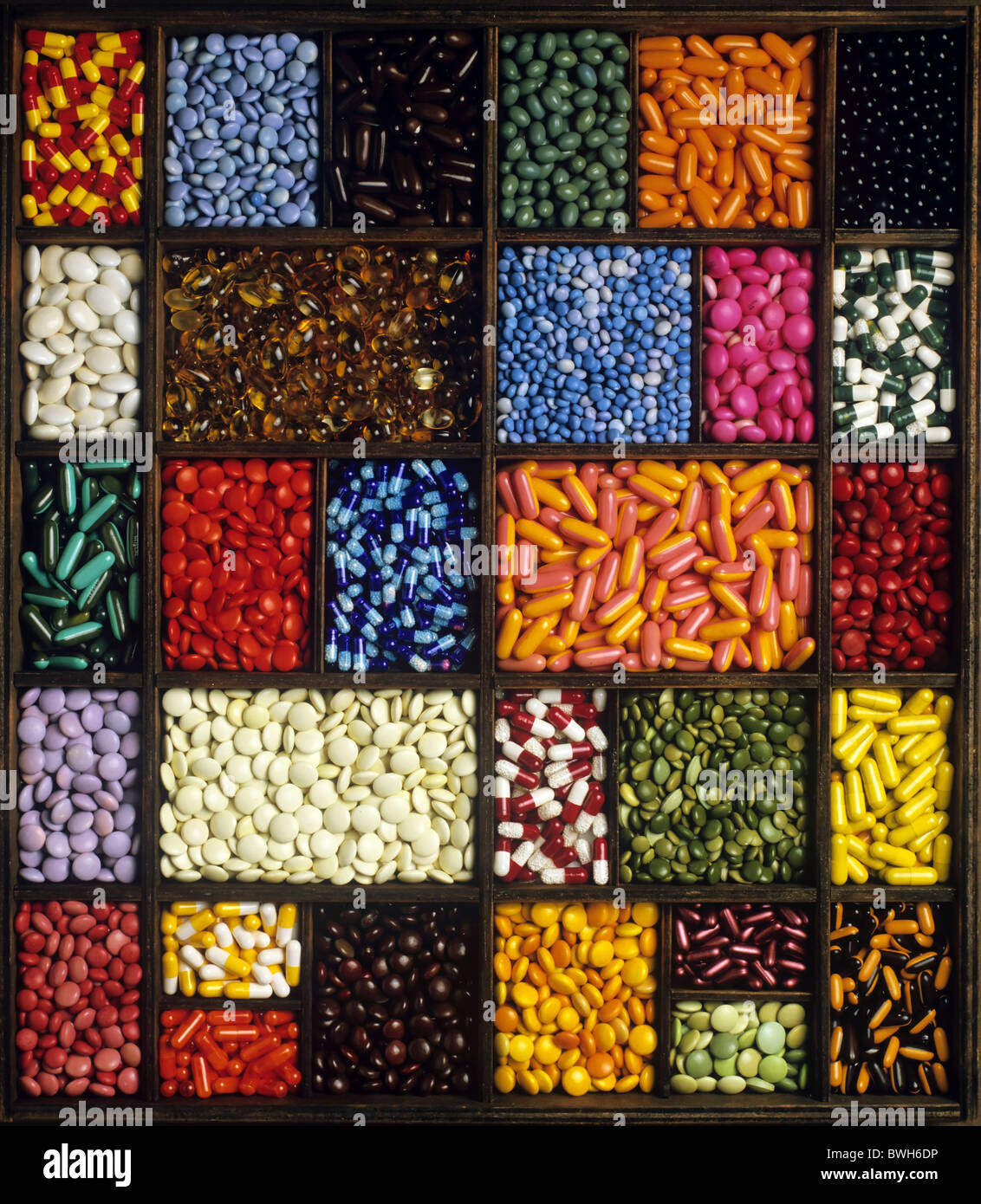 Seed tray with colored pills and capsules Stock Photo