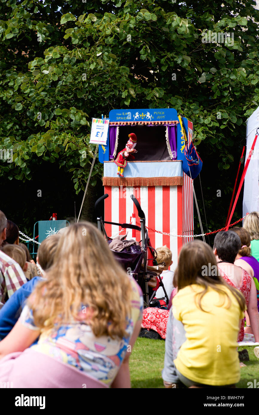 Children, Entertainment, Punch and Judy Show, Children sitting on grass watching the traditional puppet show. Stock Photo