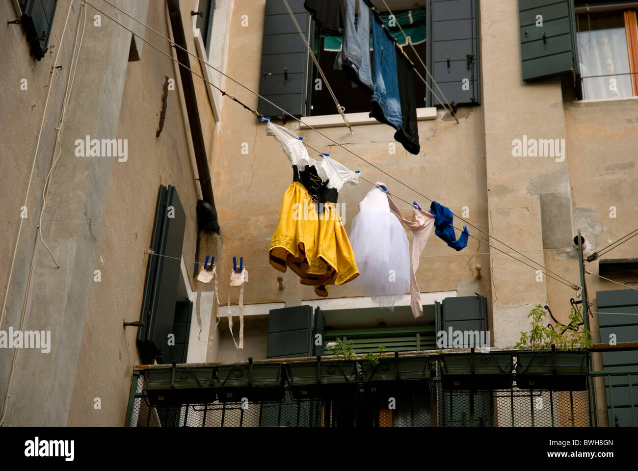 Theatrical costumes drying outside on a rope, Venice, Italy Stock Photo