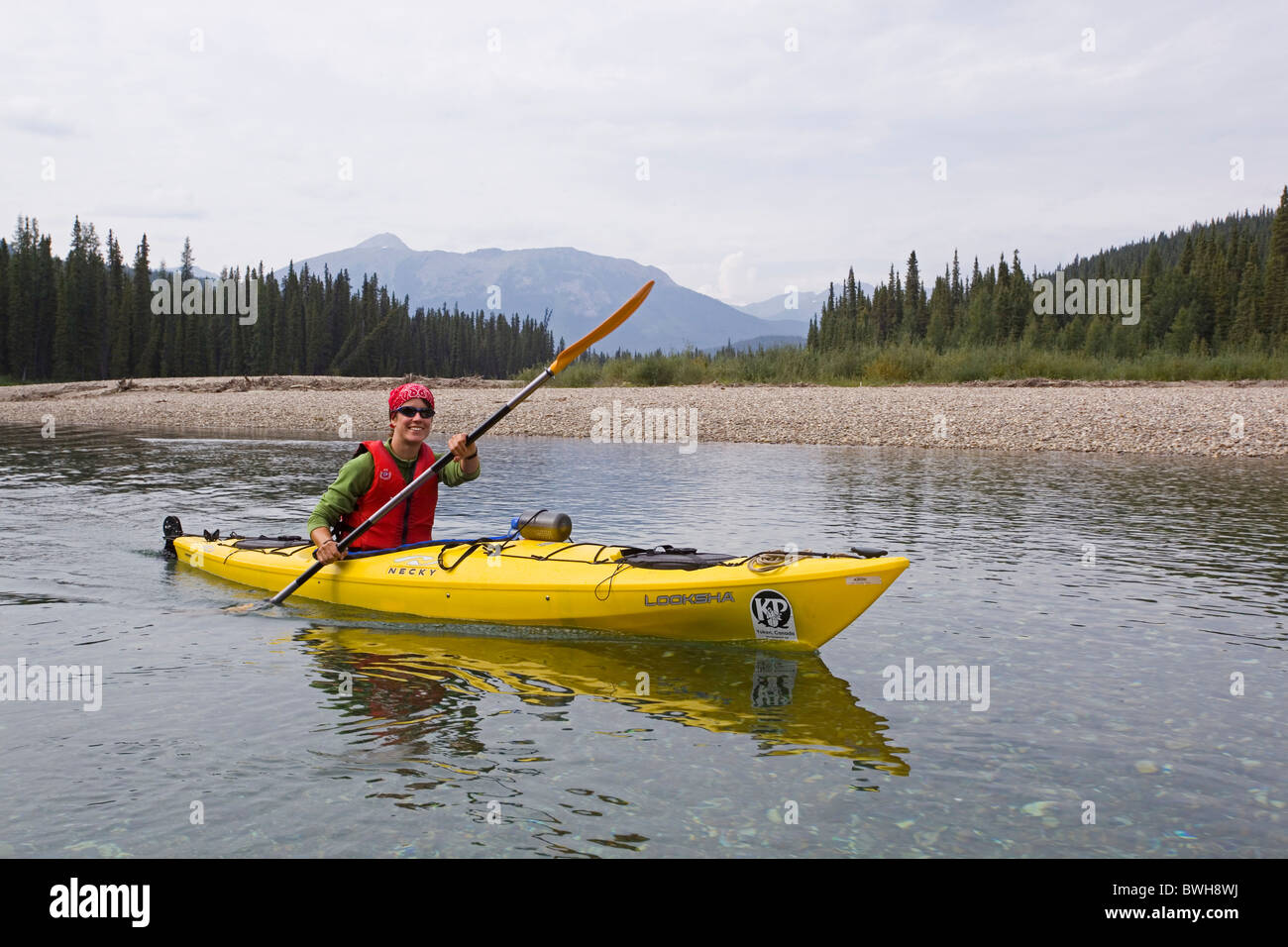 Young woman in kayak, paddling, kayaking, clear, shallow water of upper