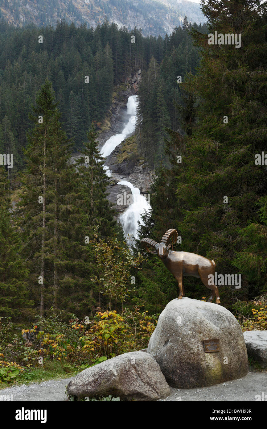 Bronze capricorn sculpture in front of the Krimmler Wasserfaelle waterfalls, Nationalpark Hohe Tauern national park, Krimml Stock Photo