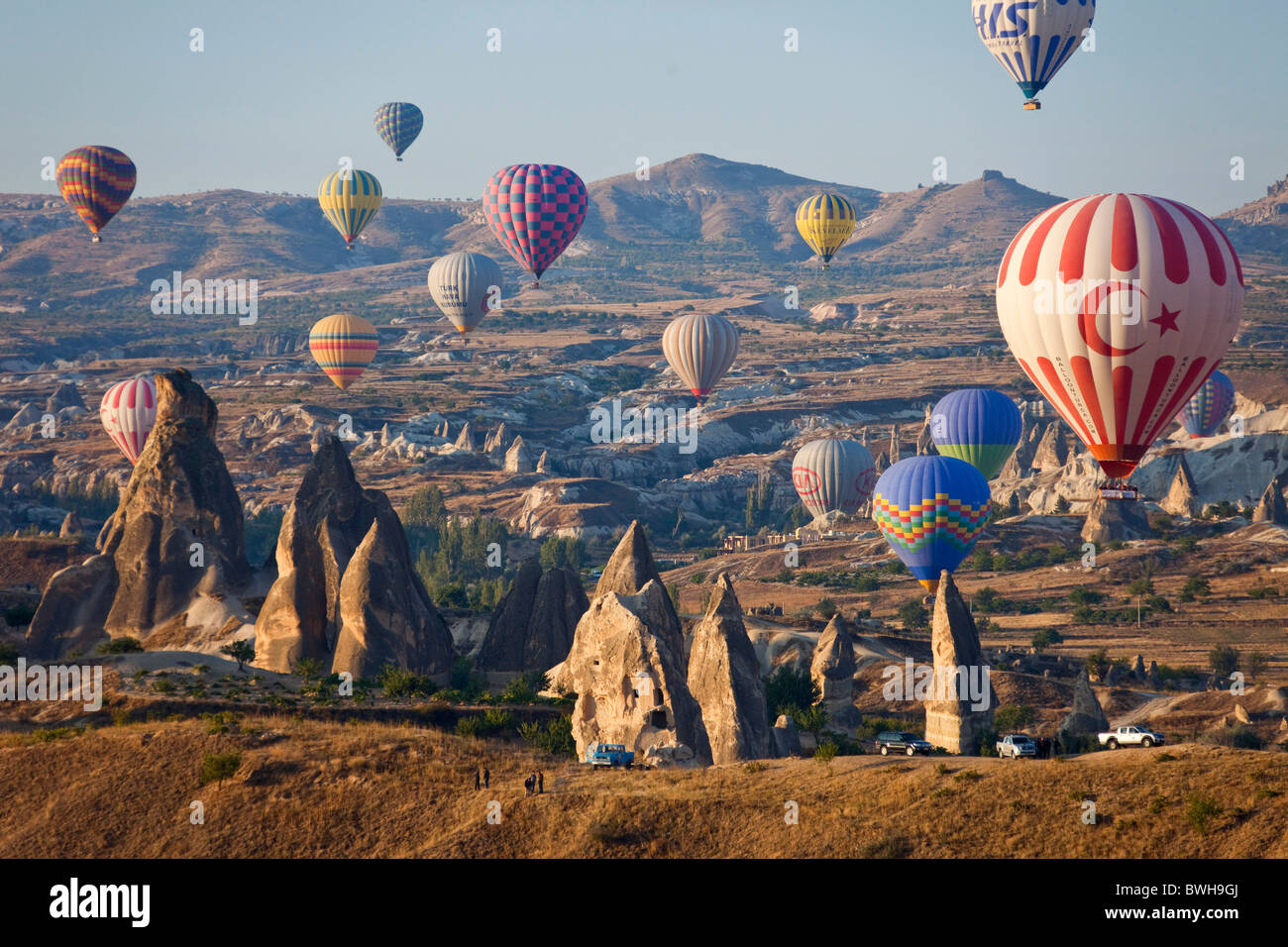 Aerial photo of Multitude of Hot air balloons in flight over Goreme National Park, Cappadocia Anatolia Turkey land 101789_Turkey Stock Photo