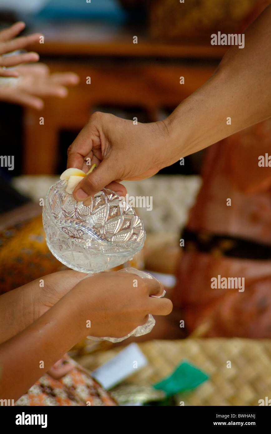 In Bali, Indonesia, holy water is distributed for a Hindu purification
