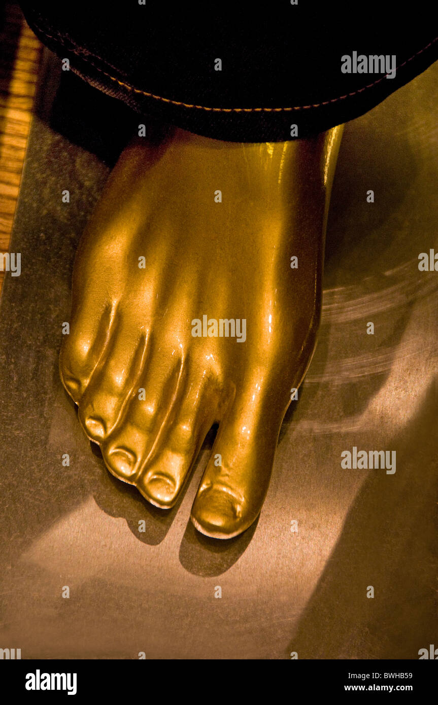 Gold painted foot on mannequin in retail store Stock Photo