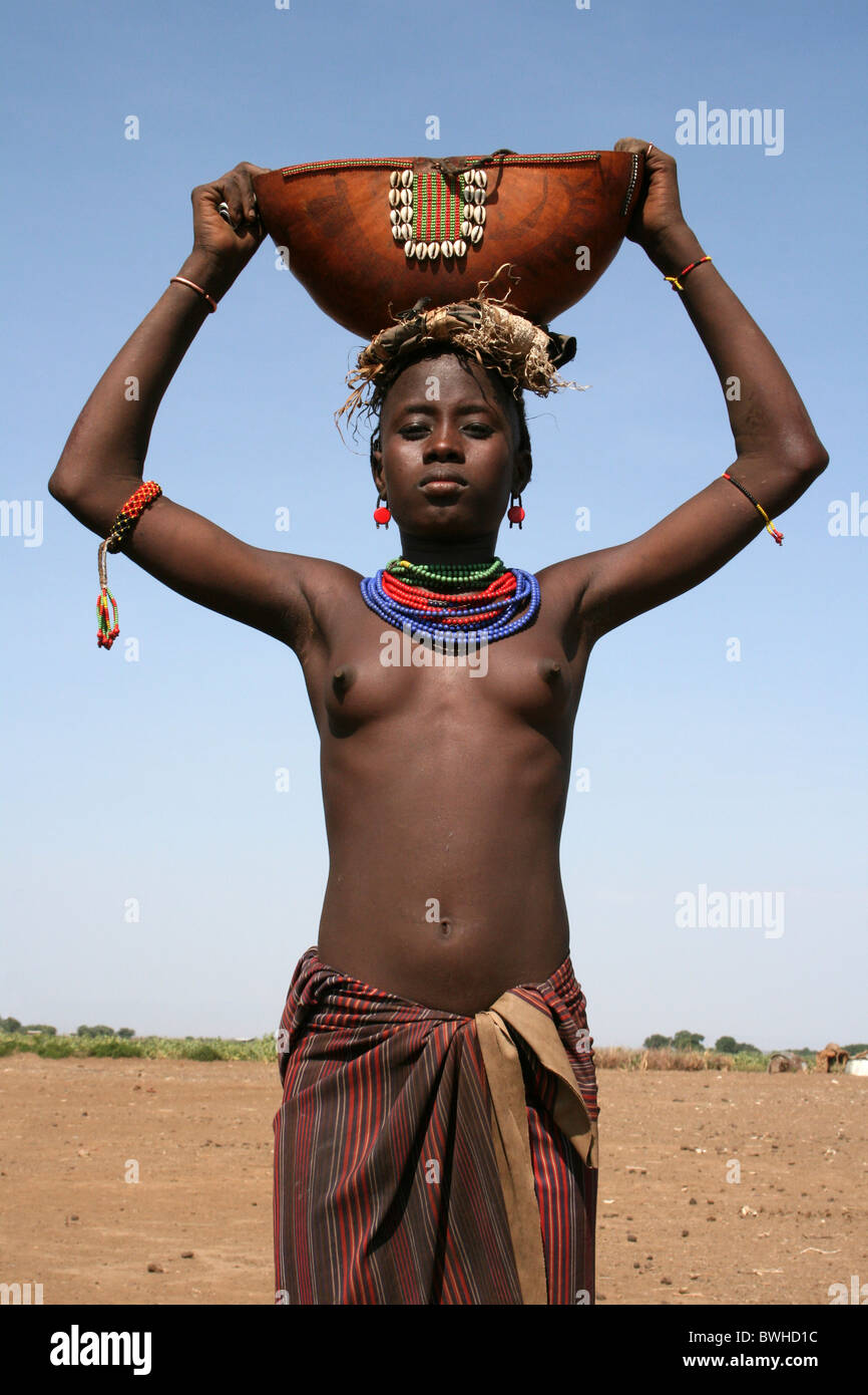 Dassanech Tribe Girl Holding Traditional Gourd, Omorate, Omo Valley, Ethiopia Stock Photo