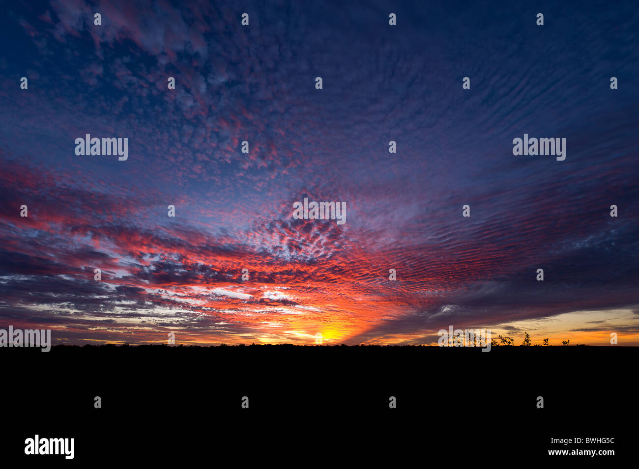Sun setting over Australian outback landscape Stock Photo