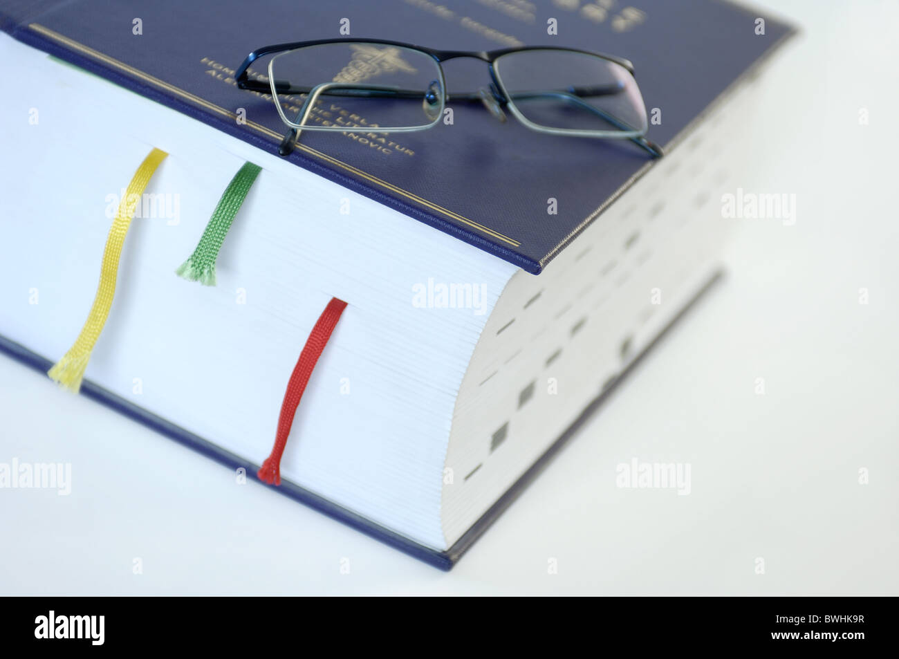 Book with reading glasses Stock Photo