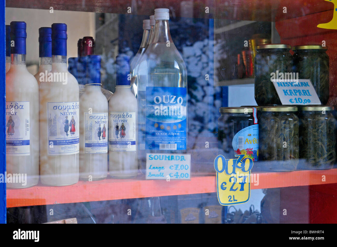 Ouzo bottles in shop window - Greece Stock Photo