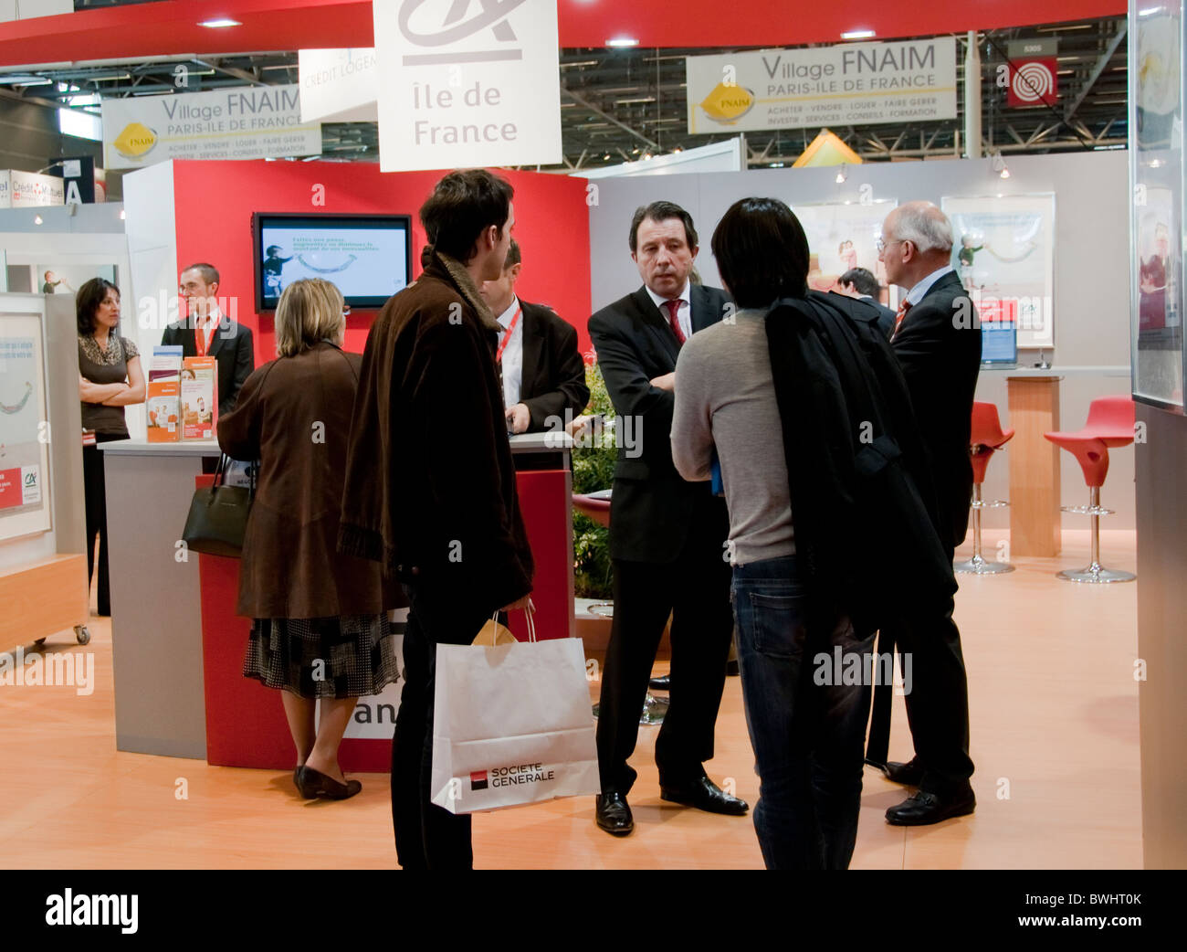 Paris, France -  Small Group People Talking, Behind, Interior View of Paris Real Estate Trade Show,  Business Meeting, French Bank, 'Credit Agricole' Trade Show Stock Photo
