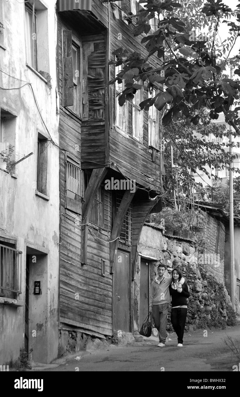 ISTANBUL, TURKEY. A young Turkish couple walking along a street in the Tophane district of the city. November 2010. Stock Photo