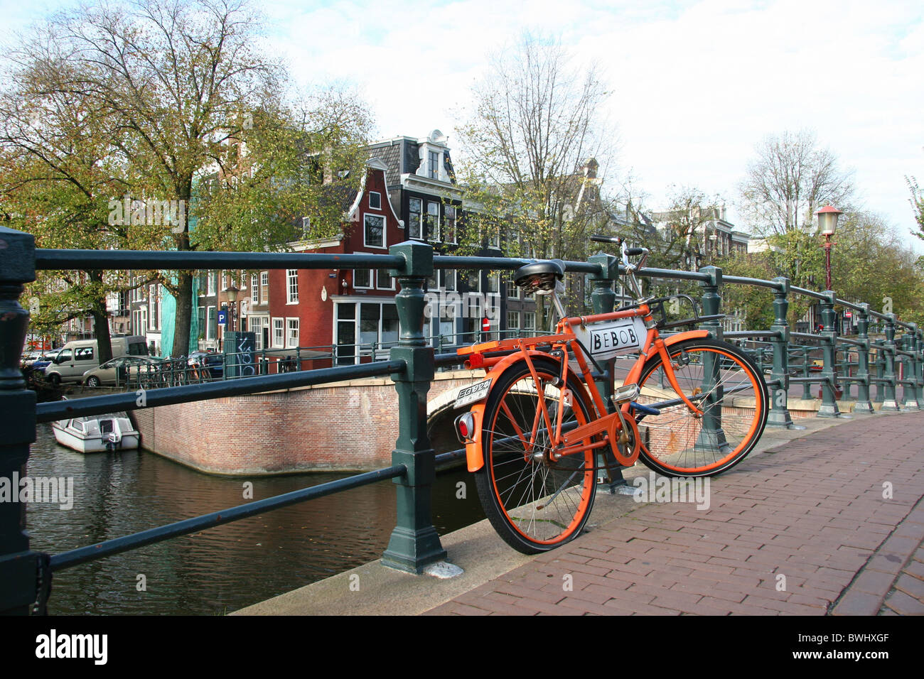 Holland Netherlands Holland Europe Amsterdam bridge bicycle bike parked Gracht canal typical row of houses Stock Photo